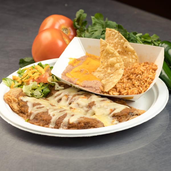 Mexican combo plate with cheesy enchiladas, side salad, rice, beans, and tortilla chips.