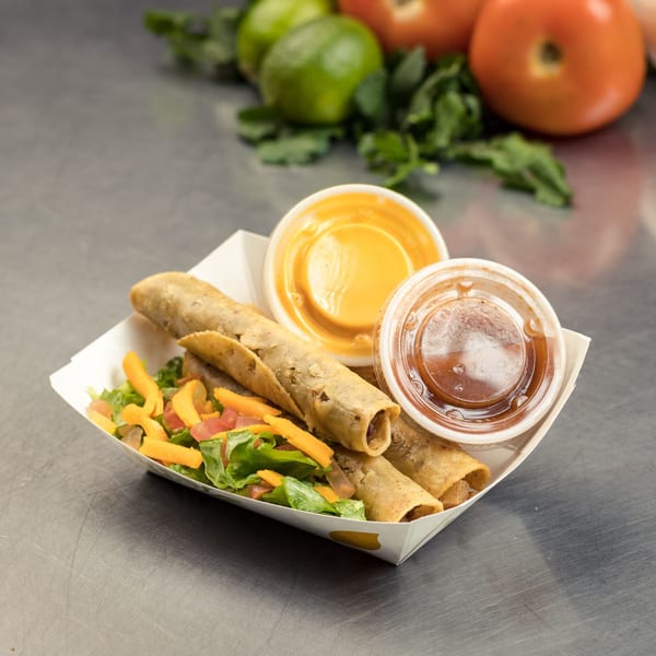 Three crispy taquitos with lettuce, cheese, and tomato, served with two dipping sauces.